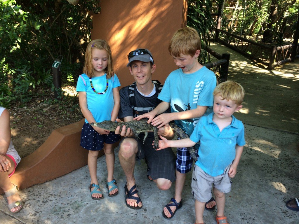 kids holding crocodile