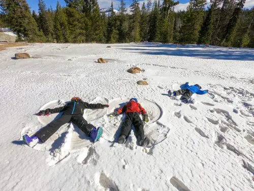 kids making snow angles in the snow