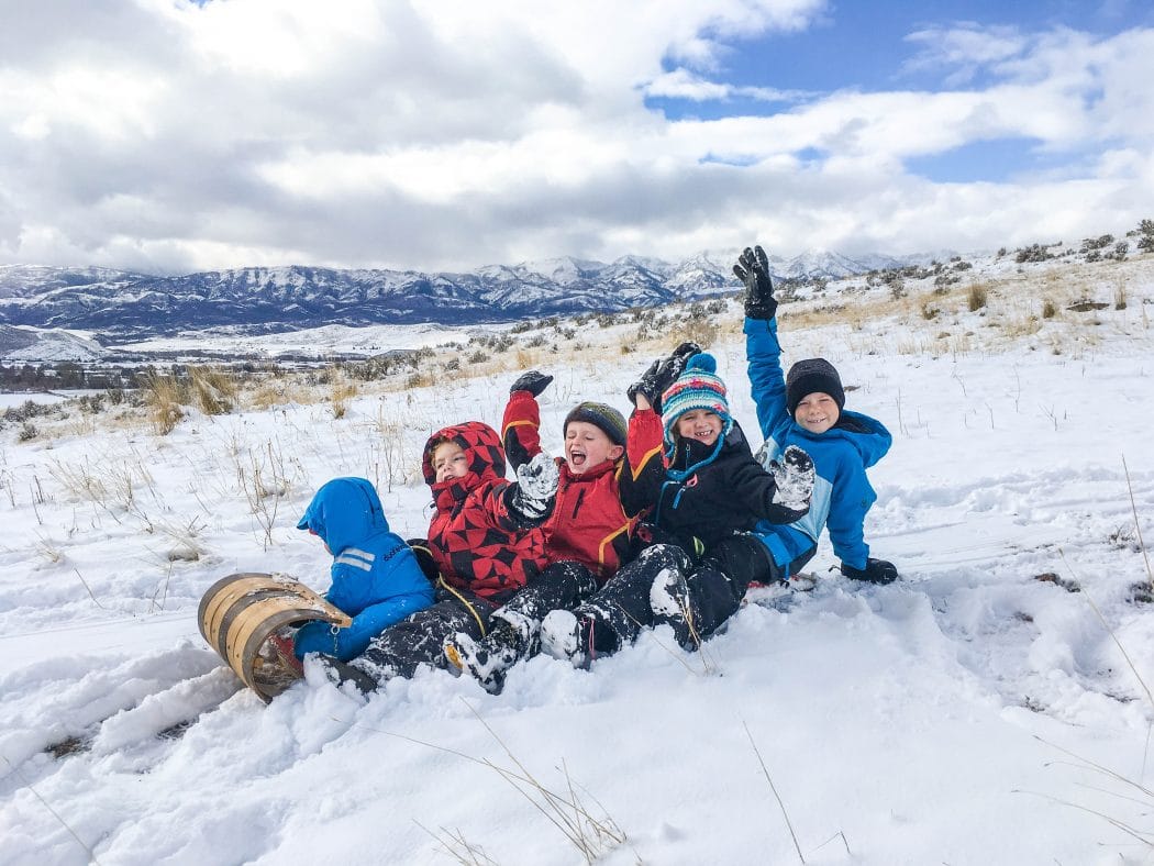 5 kids on a taboggan sledding together