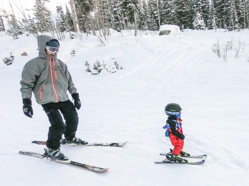 dad and baby skiing