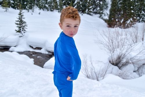 boy in the mountains in winter iksplor