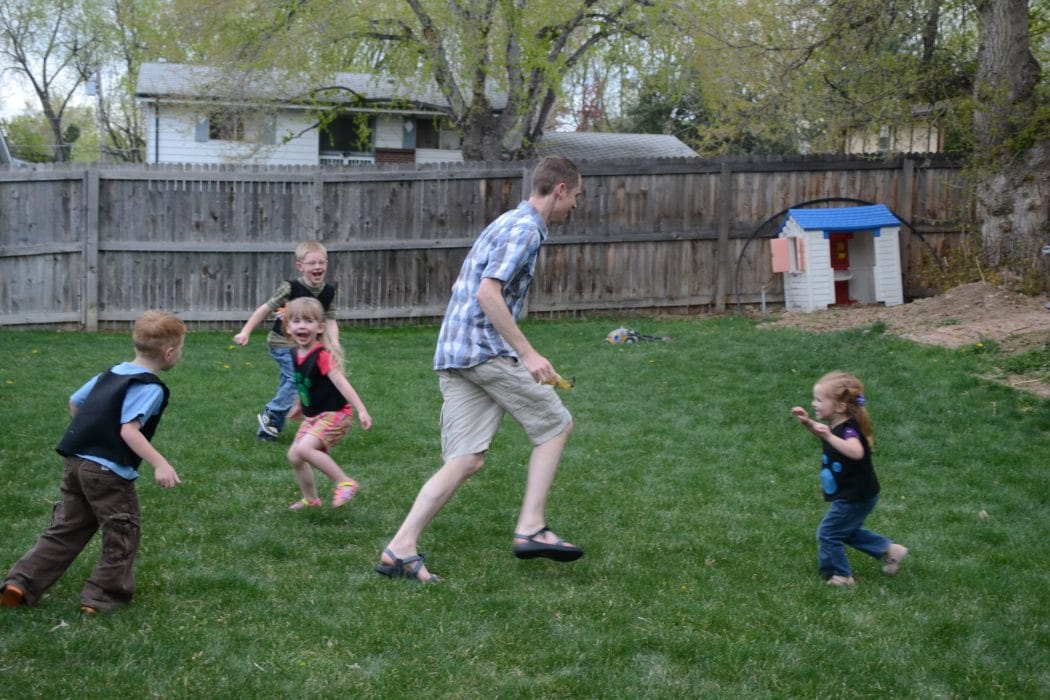 Dad playing outside with kids