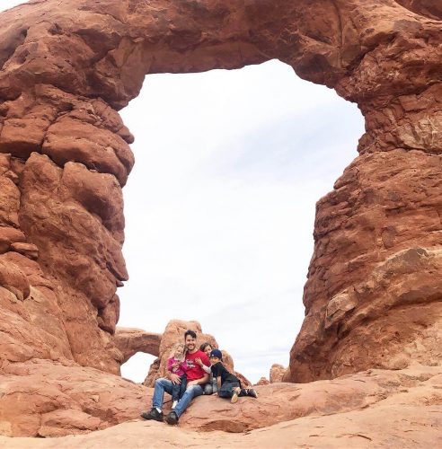 Family exploring under an arch