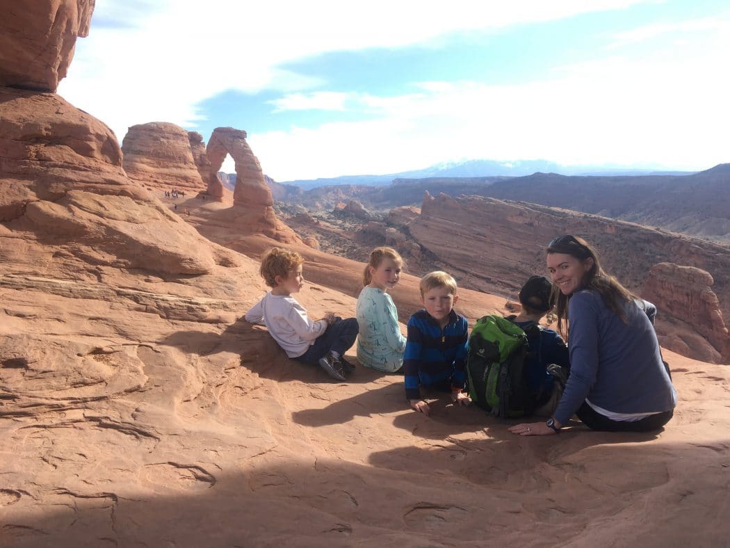 Family hiking delicate arch