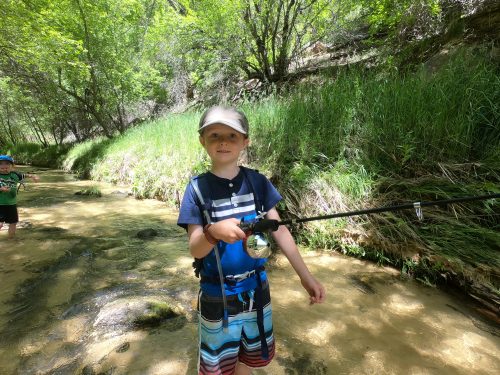 boy fishing with hydration pack