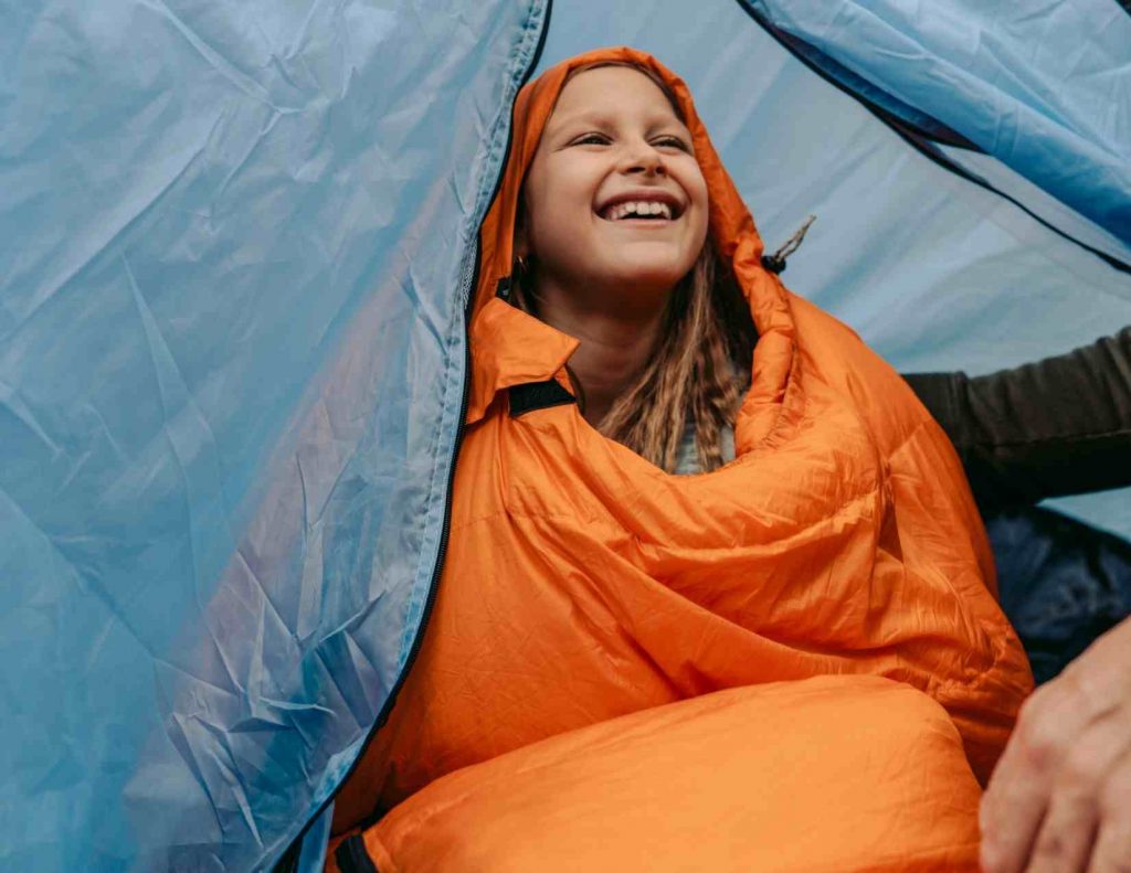 girl in sleeping bag in tent