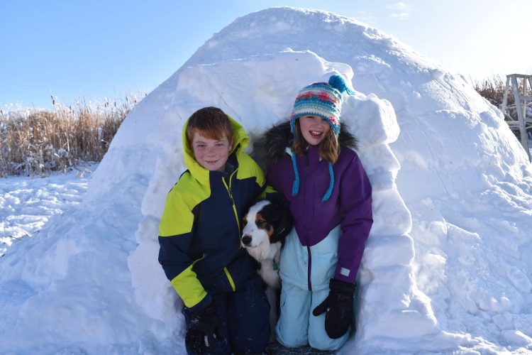 kids building a snow fort igloo