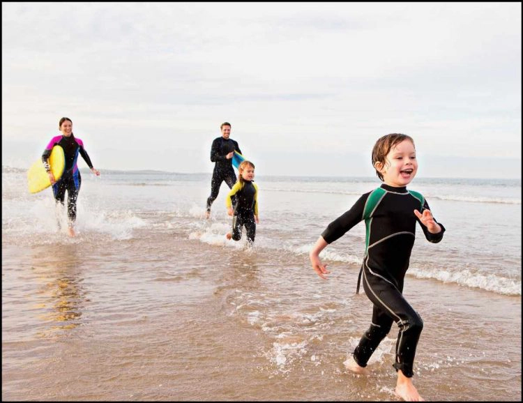 kids wetsuits at beach