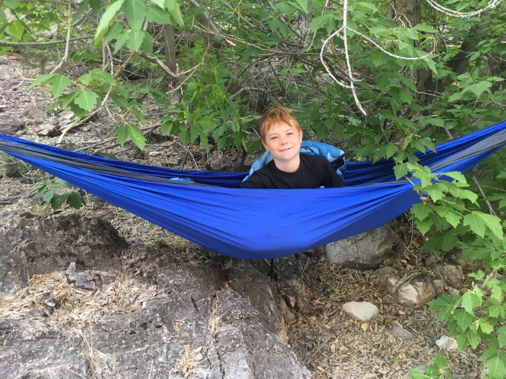 boy in hammock in the forest