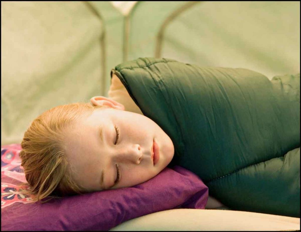 kid sleeping in tent